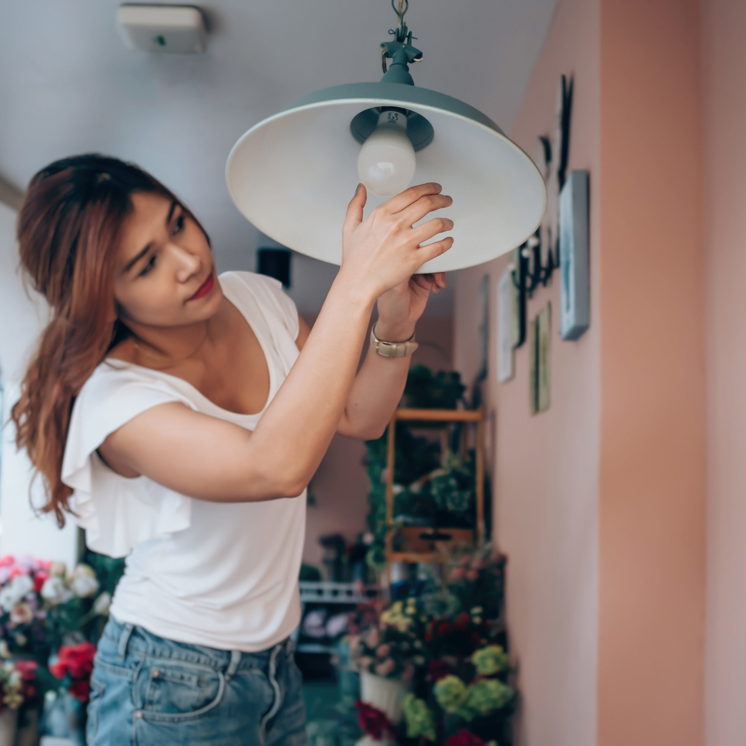 woman changing a lightbulb 